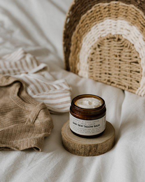 Jar of balm on a wooden block with a woven basket and fabric in the background
